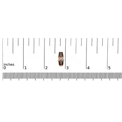 Close-up front view of single rose metal earring with white and brown gemstones in pave setting, placed on a ruler for size reference.