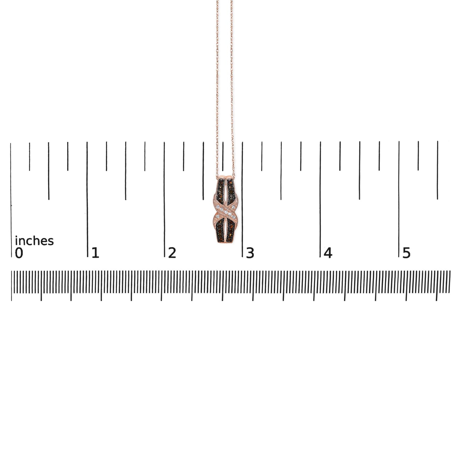 Rose metal necklace with a pendant featuring white and brown round pave-set gemstones, displayed on a ruler for size reference, front-facing angle.