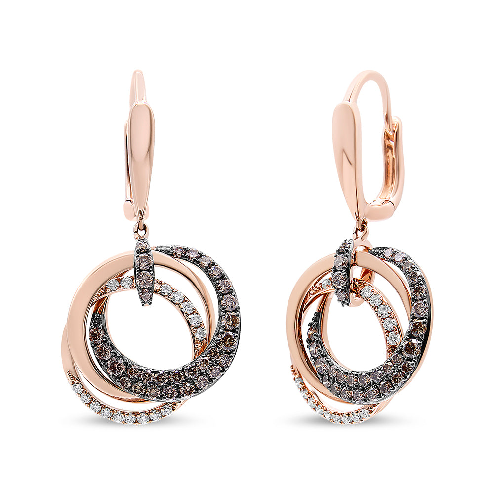 Front-facing shot of rose metal earrings with multiple intertwined circular loops, adorned with white and brown round gemstones in various settings.