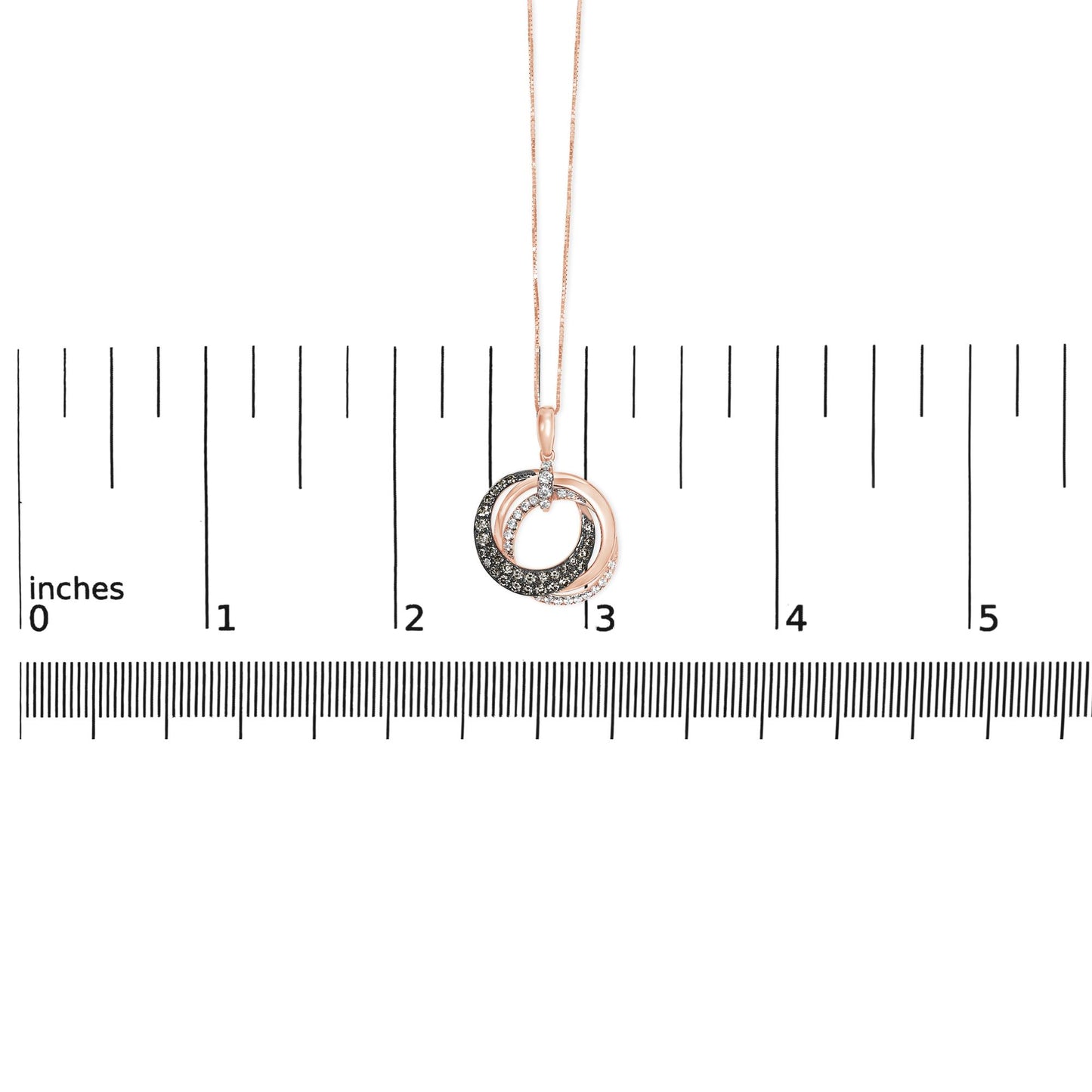 Rose metal necklace with two intertwined circular pendants, one set with white gemstones and the other with brown gemstones, shown front-facing on a ruler for size reference.