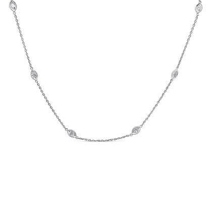 Front angled view of a white metal chain necklace with multiple round white gemstones set in bezel settings evenly spaced along the chain.