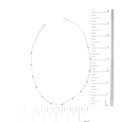 White metal necklace with round white gemstones in bezel settings along a linked chain, shown from a top-down angle on a ruler scale.