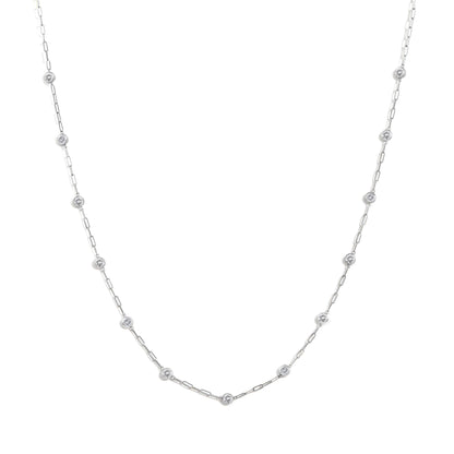 Close-up front view of a white metal necklace with round white gemstones in bezel settings evenly spaced along an elongated linked chain, shown on a white background.