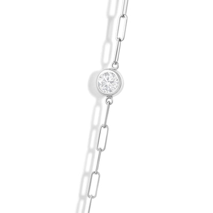 Close-up angled view of a white metal necklace chain featuring a round white gemstone in a bezel setting.