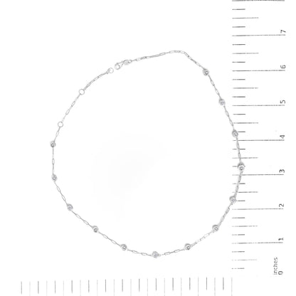 White necklace with round white gemstones in bezel settings spaced along a delicate chain, shown flat on a scale, top-down view.