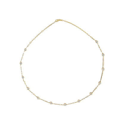 Yellow necklace with round white gemstones in bezel settings, shown flat in a top-down angle.