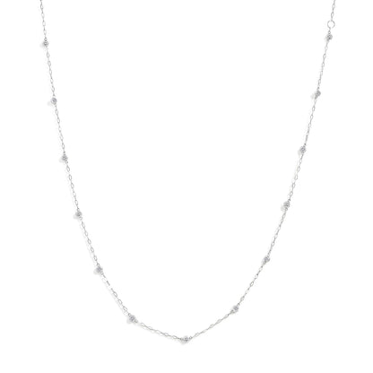 Close-up front view of a white necklace chain featuring round bezel-set white gemstones evenly spaced along the chain, shown on a white background.