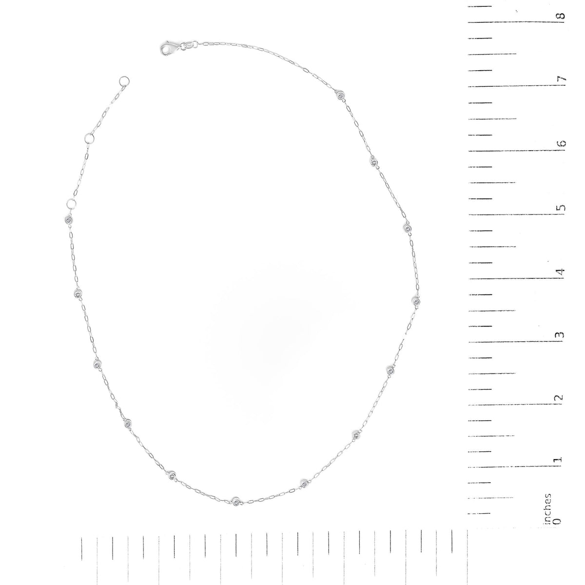 White metal necklace with evenly spaced round white gemstones in bezel settings, shown flat on a scale, top-down angle.