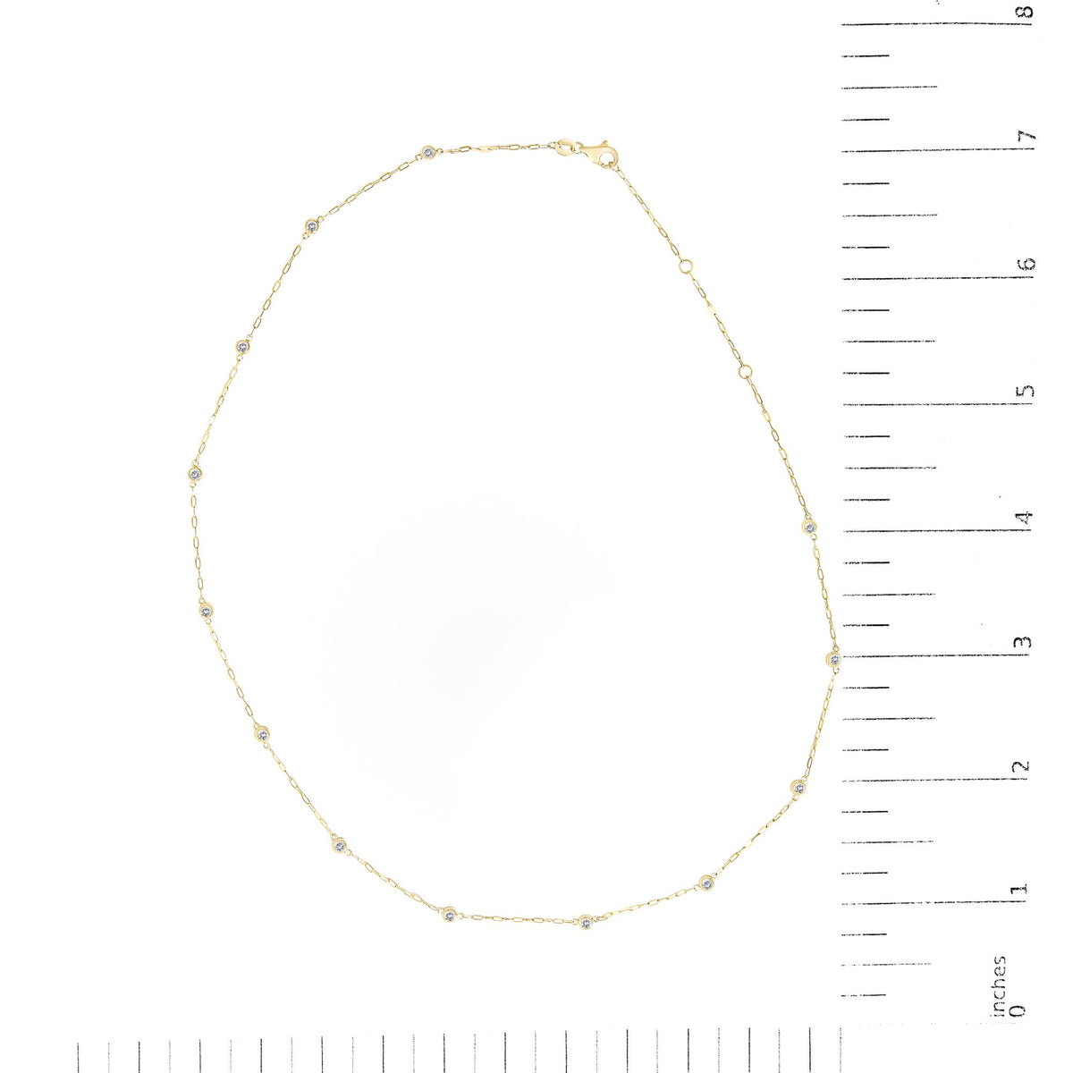 Yellow necklace with bezel-set round white gemstones spaced along a thin chain, shown flat on a scale, top-down view.