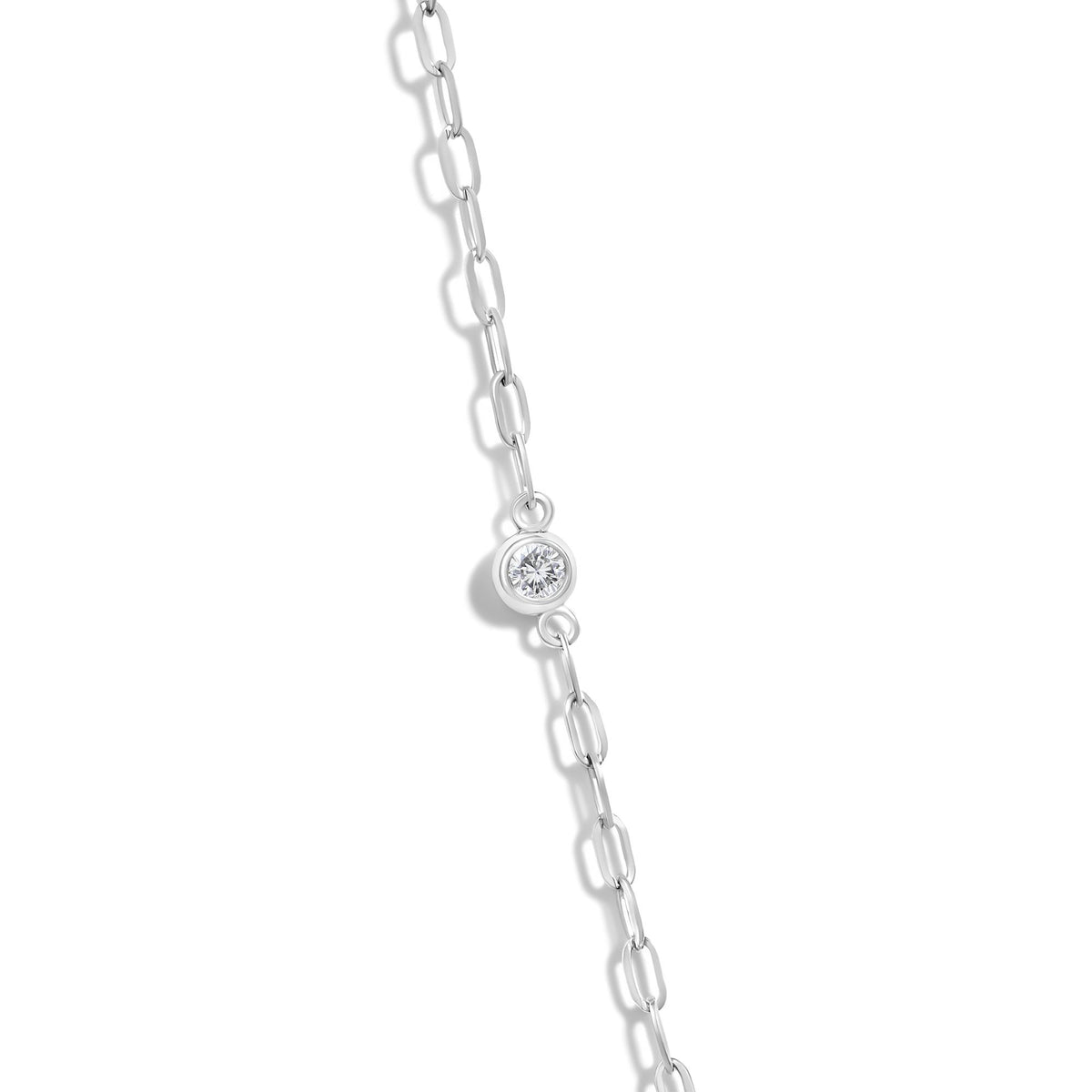 Close-up of 14K gold 1/4 cttw diamond paperclip station necklace showcasing a bezel-set round diamond on white background