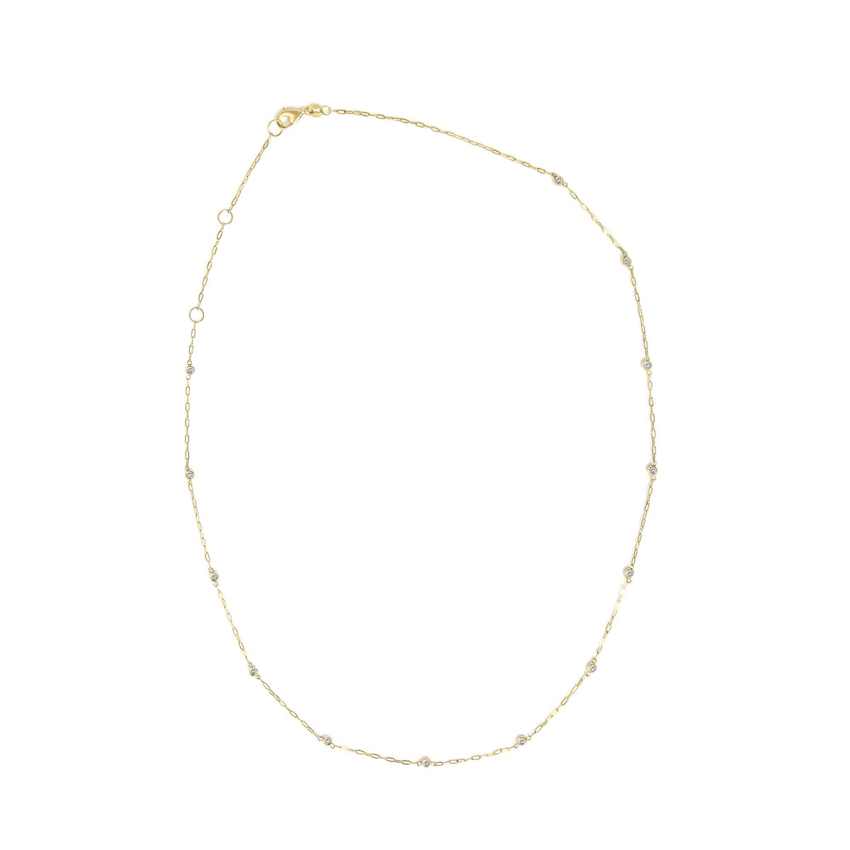 Close-up top view of a yellow necklace chain with round white gemstones in bezel settings evenly spaced along the chain, shown on a white background.