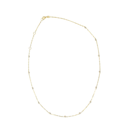 Close-up top view of a yellow necklace chain with round white gemstones in bezel settings evenly spaced along the chain, shown on a white background.