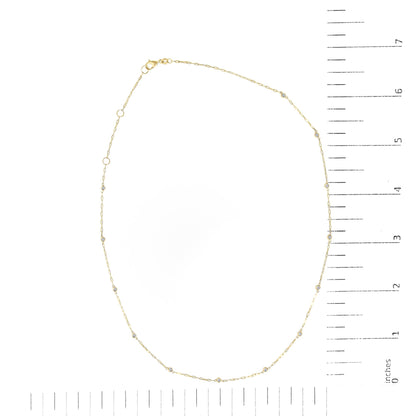 Yellow necklace with round white gemstones in bezel settings, shown flat on a scale, top-down view.