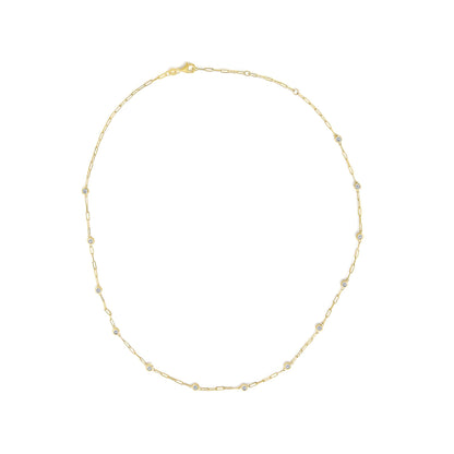 Close-up front view of a yellow metal necklace with round white gemstones in bezel settings spaced evenly along a chain with small oval links, shown on a white background.