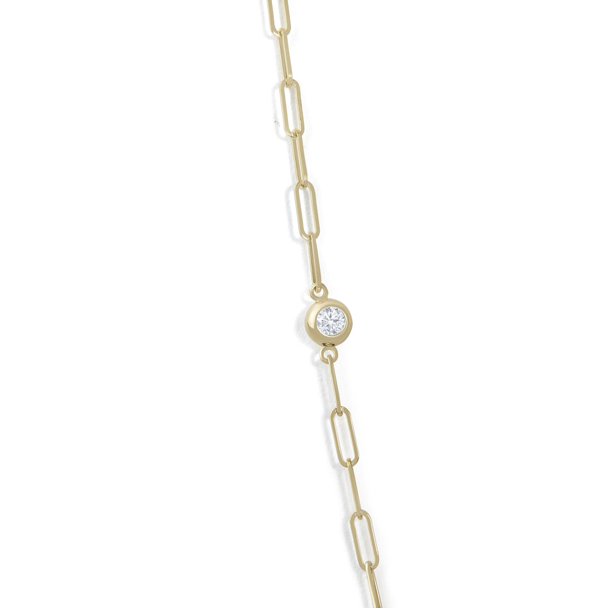 Close-up angled view of a yellow metal necklace chain link with a round white gemstone set in a bezel setting.