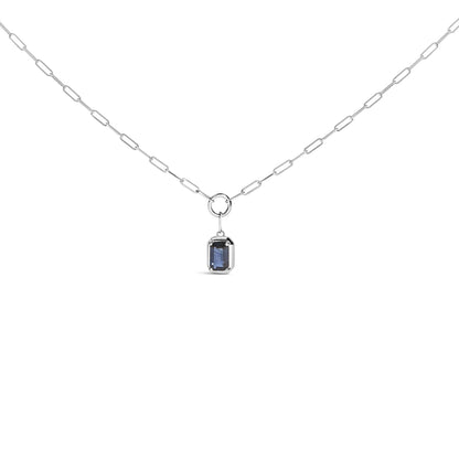 Front view of a white metal necklace with a rectangular blue gemstone in a bezel setting hanging from a chain with elongated links.