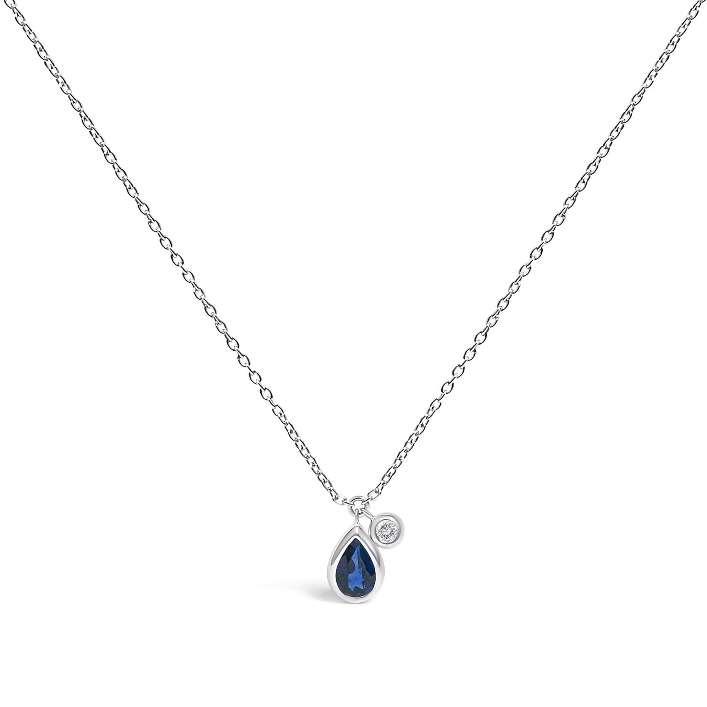 White necklace with pear-shaped blue gemstone and round white gemstone pendants in bezel settings, shown in a centered front-facing view.