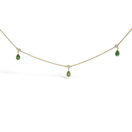 Front-facing close-up of a yellow necklace chain featuring alternating white round gemstones and green pear-shaped gemstones in bezel settings.