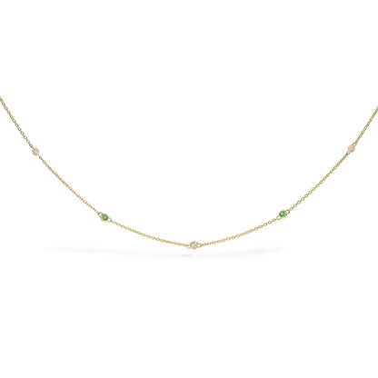 Yellow necklace with alternating round white and green gemstones in bezel settings, shown flat on a white background from a front angle.