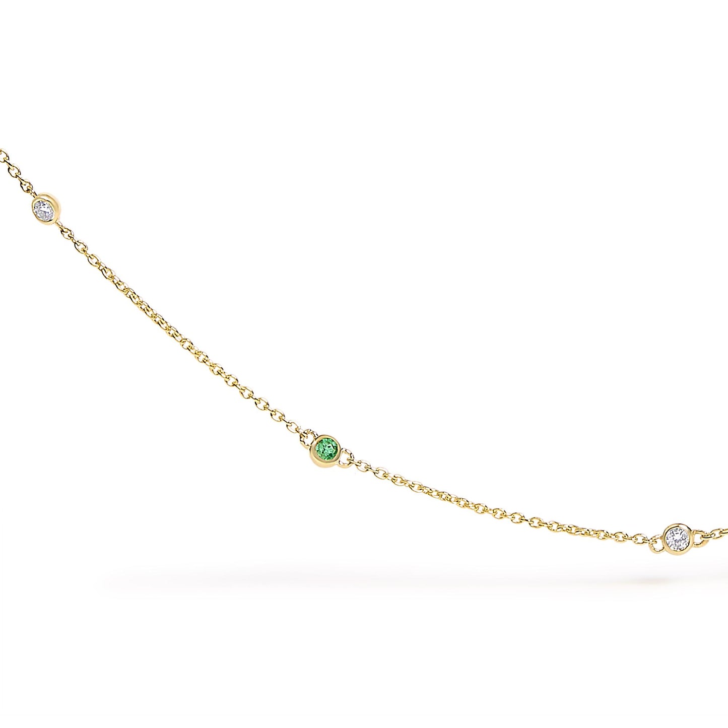 Close-up front view of a yellow metal necklace chain with round bezel-set white and green gemstones spaced along the chain.