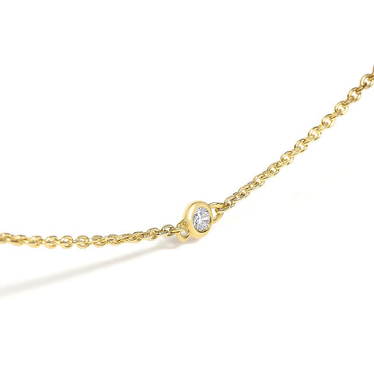 Close-up angled view of a yellow necklace chain with a round white gemstone bezel set in the center.