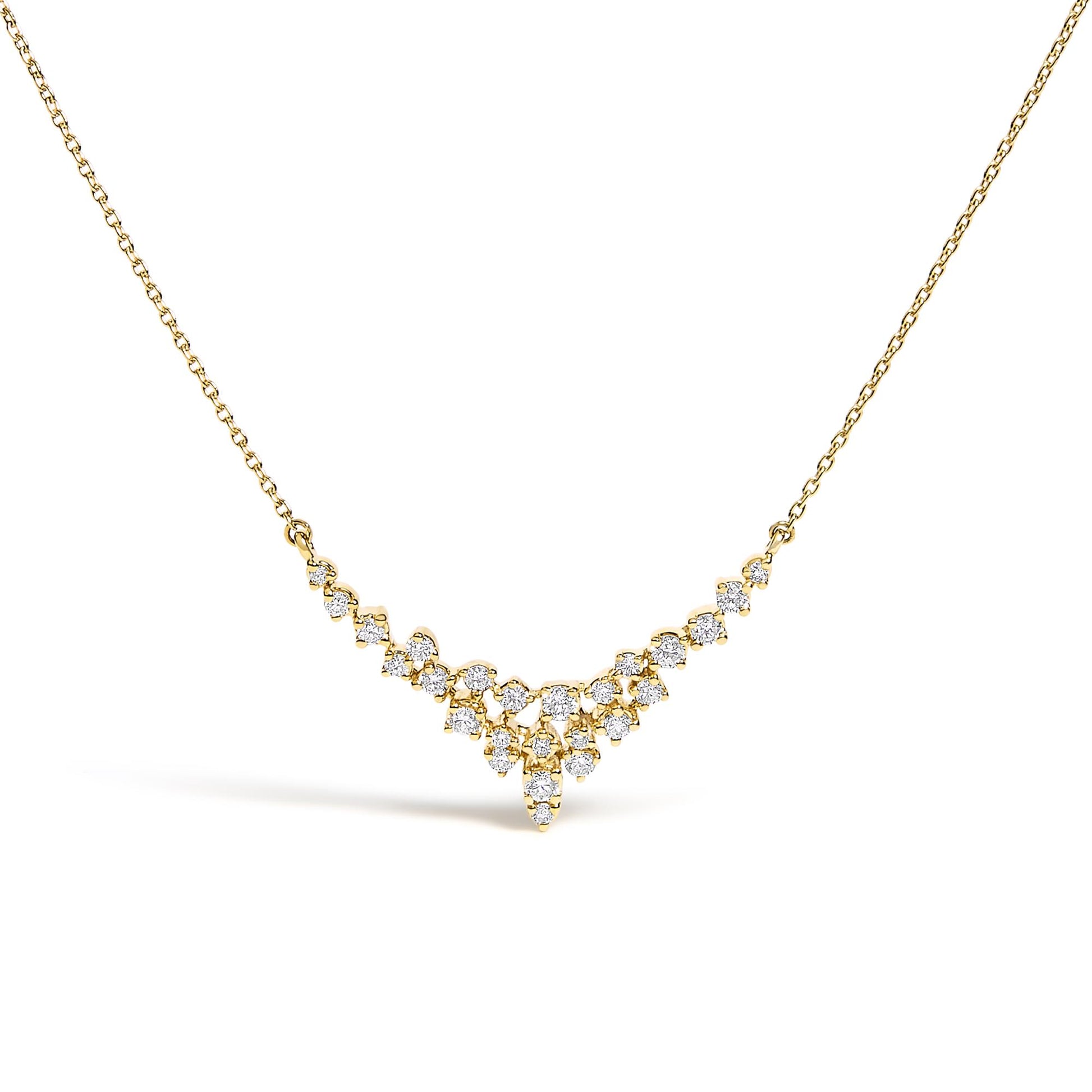 Front-facing close-up of a yellow metal necklace with a V-shaped cluster of round white gemstones in prong settings.