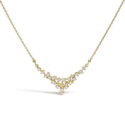 Front-facing close-up of a yellow metal necklace with a V-shaped cluster of round white gemstones in prong settings.