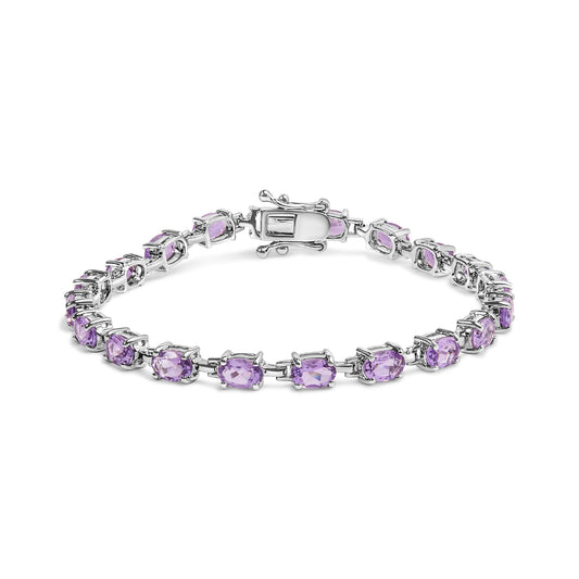 White bracelet featuring oval purple gemstones in four-prong settings, shown from a front angle.