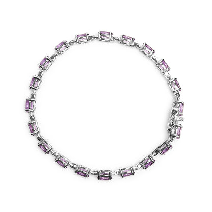 White metal bracelet with oval purple gemstones in 4-prong settings, shown in a flat lay top-down view.