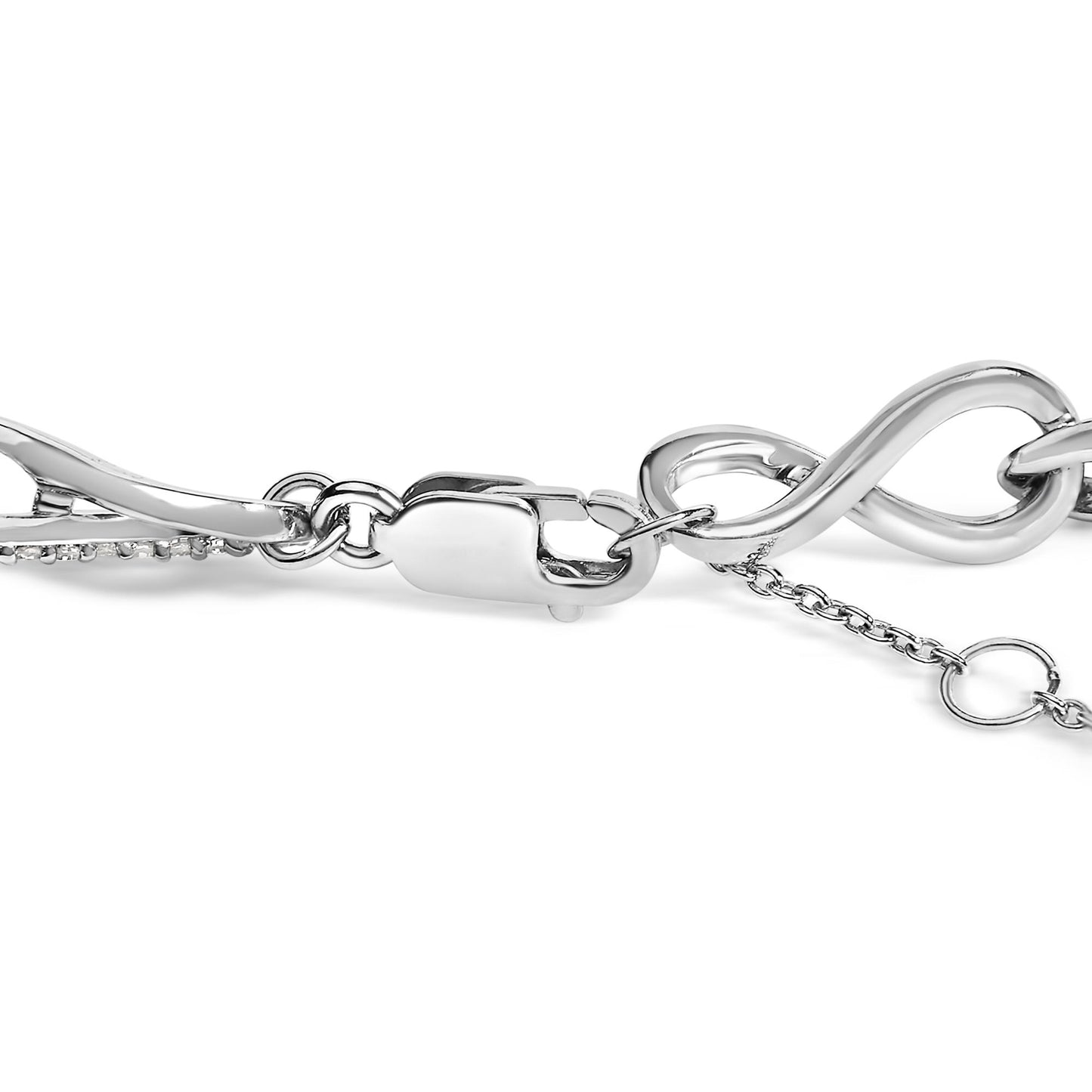 Close-up side view of a white metal bracelet with an infinity symbol, a lobster clasp, and a chain extender showing prong-set round white gemstones along part of the bracelet.