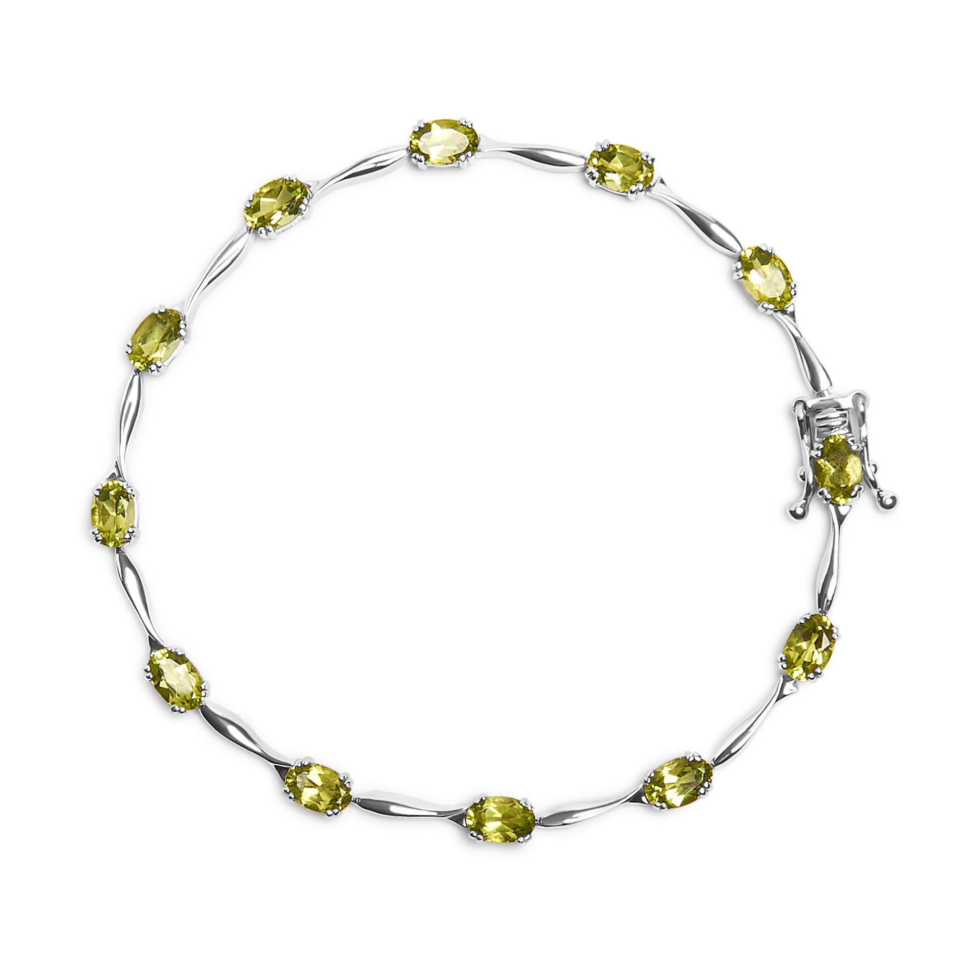 Top-down view of a white metal bracelet featuring oval green gemstones in four-prong settings, arranged in a continuous circle with a decorative clasp.