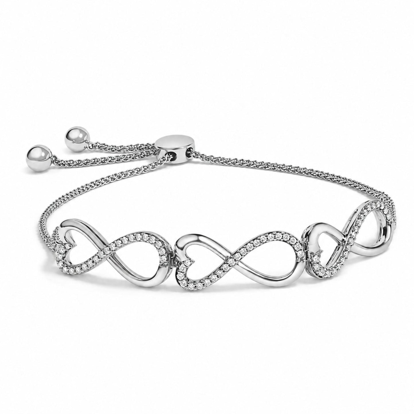 Close-up front angle of a white metal bracelet with an adjustable chain and sliding clasp, featuring an infinity symbol design adorned with round white gemstones in a prong setting.