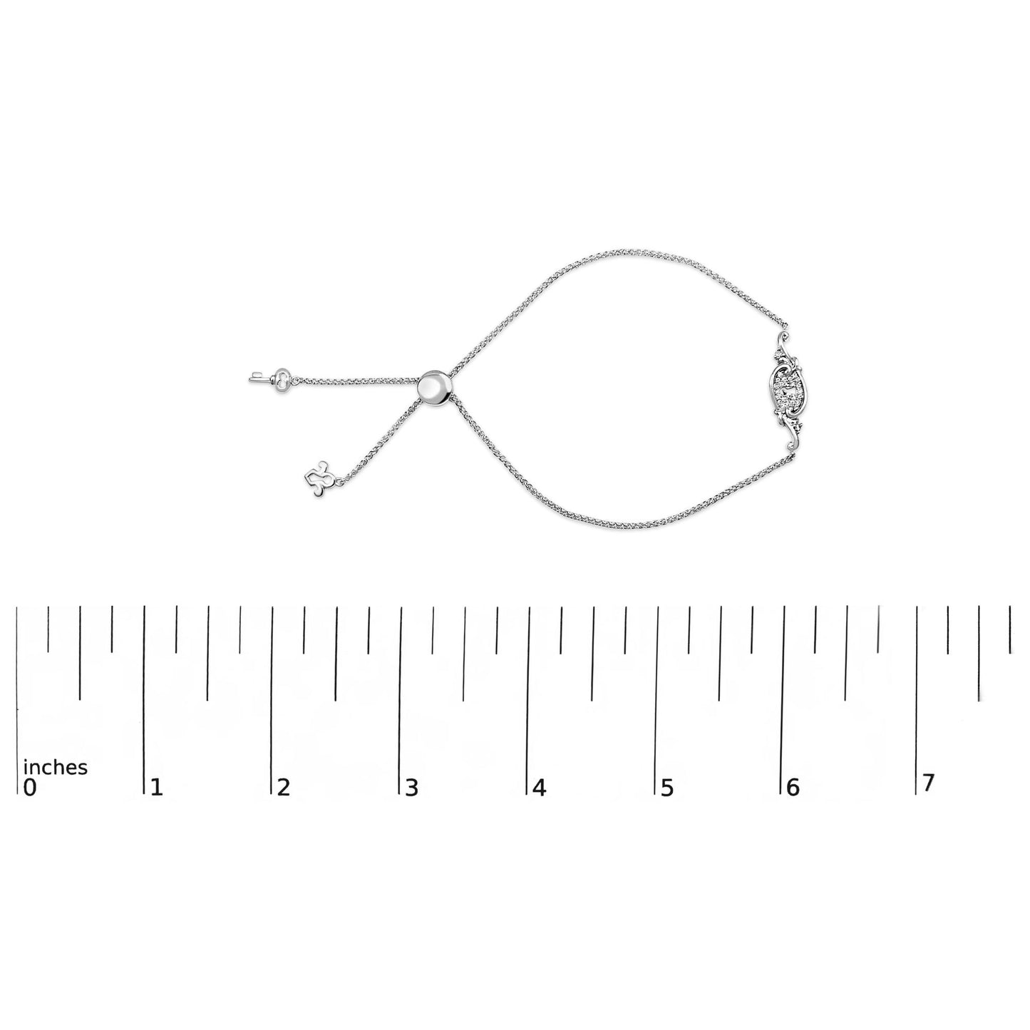 White metal bracelet with round white gemstones in shared prong setting, displayed flat on a ruler scale, top-down angle.