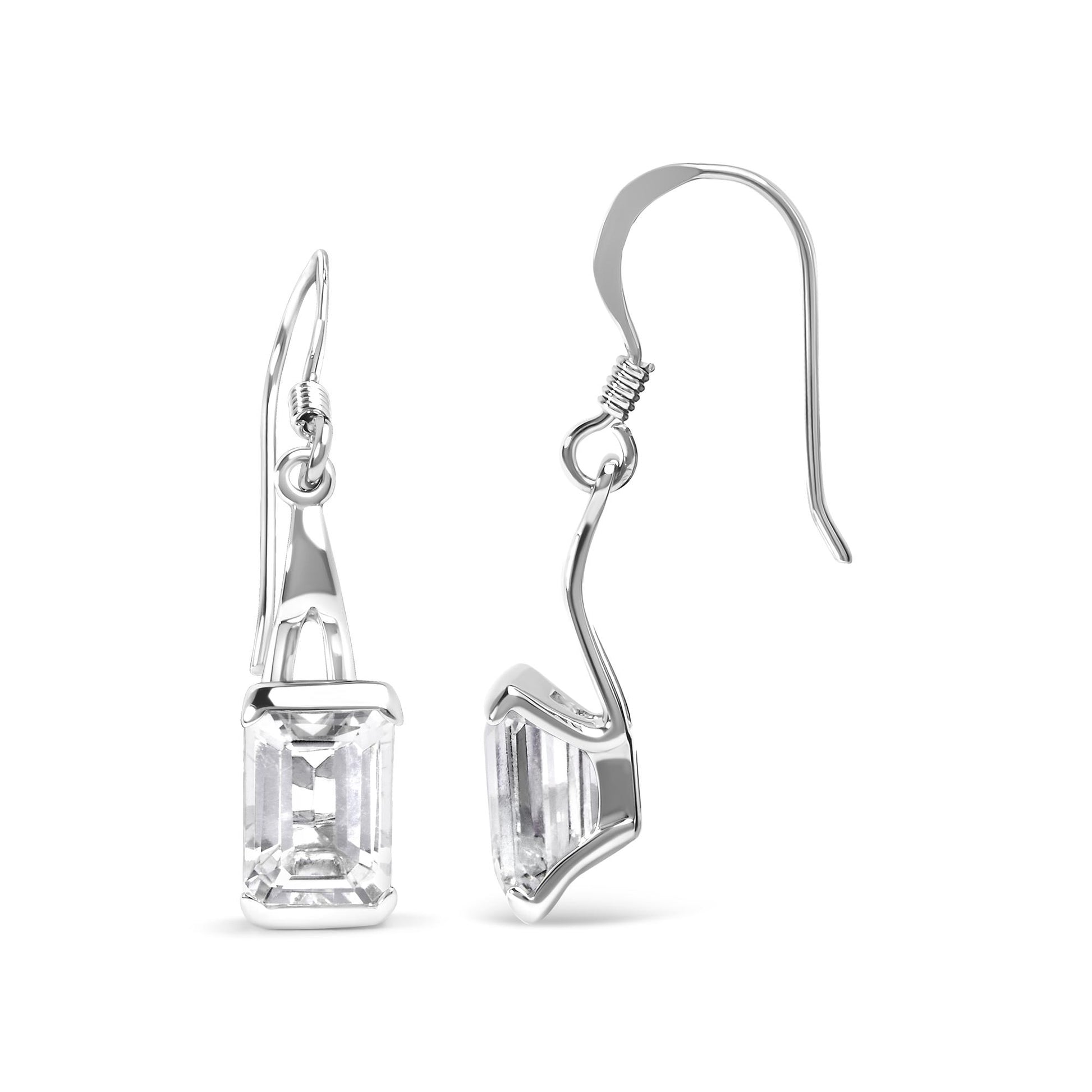 Pair of white metal earrings with emerald-shaped white gemstones in 4-prong settings, shown from front and side angles on a white background.