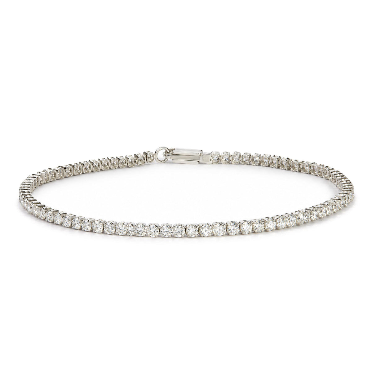 White bracelet with round white gemstones in prong settings, shown flat on a white surface, close-up front angle view.