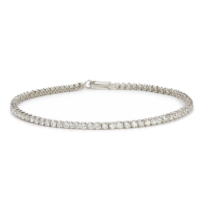 White bracelet with round white gemstones in prong settings, shown flat on a white surface, close-up front angle view.