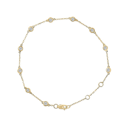 Top-down view of a yellow bracelet with a delicate chain featuring bezel-set round white gemstones evenly spaced, shown on a white background.