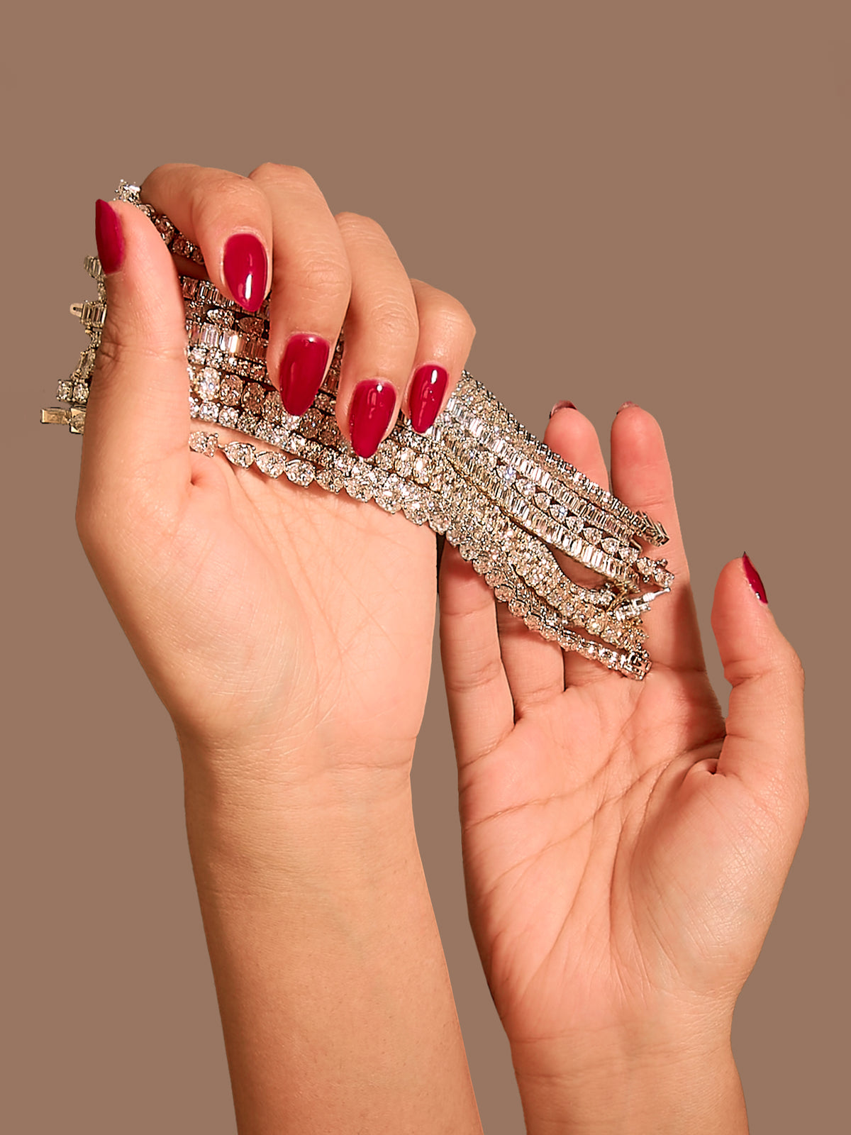 Haus of Brilliance hands holding multiple bracelets