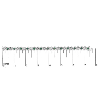 White bracelet with alternating white gemstones and green gemstones in a twisted design, shown flat on a scale from 0 to 8 inches, front facing.