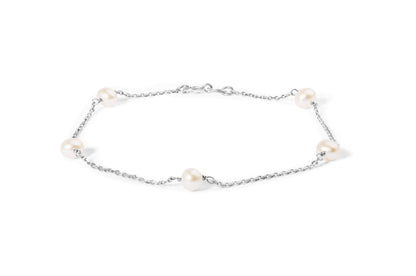 White metal chain bracelet with evenly spaced white gemstones, shown flat from a top-down angle on a white background.