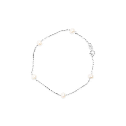 White metal bracelet with round white gemstones spaced along a delicate chain, shown flat from above.