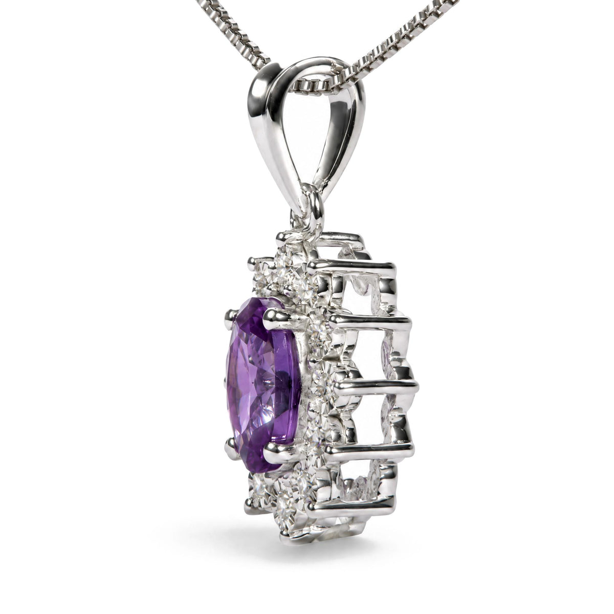 Close-up angled view of a white metal necklace pendant featuring a large oval purple gemstone center, surrounded by round white gemstones in a structured setting. The necklace chain is a white metal box chain.