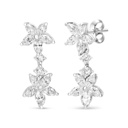 Front angle view of white metal floral-shaped earrings with marquise and round white gemstones in prong settings.