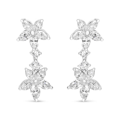 Front-facing shot of white metal earrings featuring two flower shapes composed of marquise-shaped white gemstones, connected by two round-shaped white gemstones in prong settings.