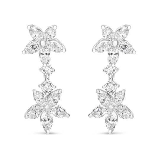 Front-facing shot of white metal earrings featuring two flower shapes composed of marquise-shaped white gemstones, connected by two round-shaped white gemstones in prong settings.