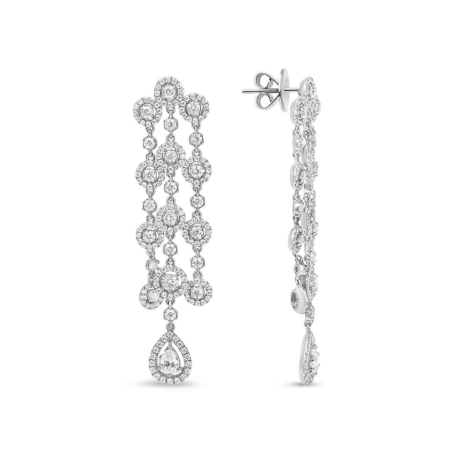 Front and side views of long white metal drop earrings with multiple small round white gemstones in prong and pave settings and a pear-shaped white gemstone at the bottom, shot on a white background.