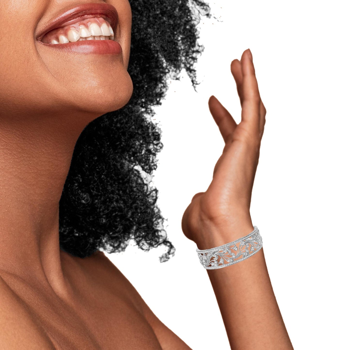 White metal bracelet with intricate filigree and round white gemstones in a pave setting, worn on a model’s wrist, side view.