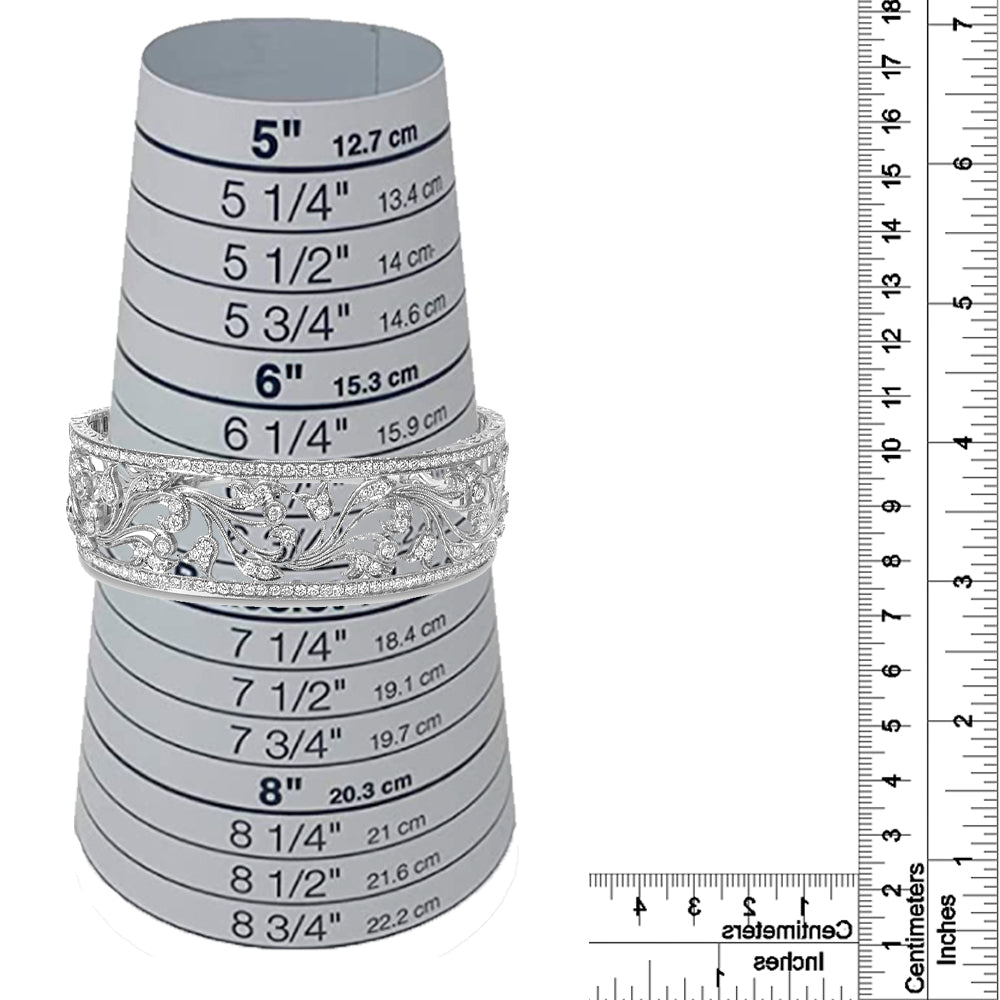 White metal bracelet with intricate openwork floral design and round white gemstones in pave setting, displayed on a size measurement cone with rulers for size reference, front-facing angle.