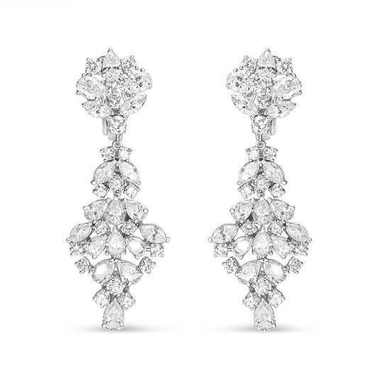 Front-facing view of white metal drop earrings featuring an intricate arrangement of marquise, oval, round, and pear-shaped white gemstones in prong settings.