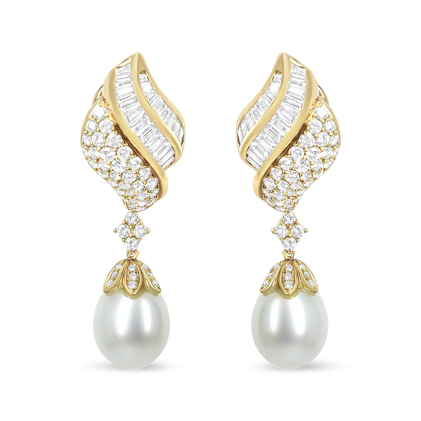 Front view of yellow metal drop earrings with curved design featuring channel-set white baguette-shaped gemstones, pavé-set round white gemstones, and large white pearl drops.